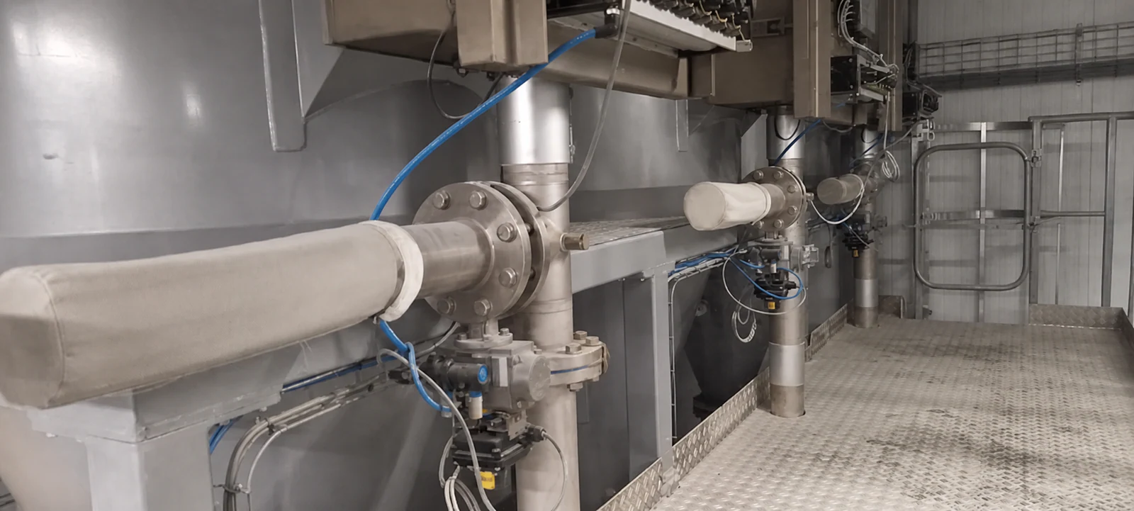 Industrial filtration and clean-air pipework inspected during field verification.